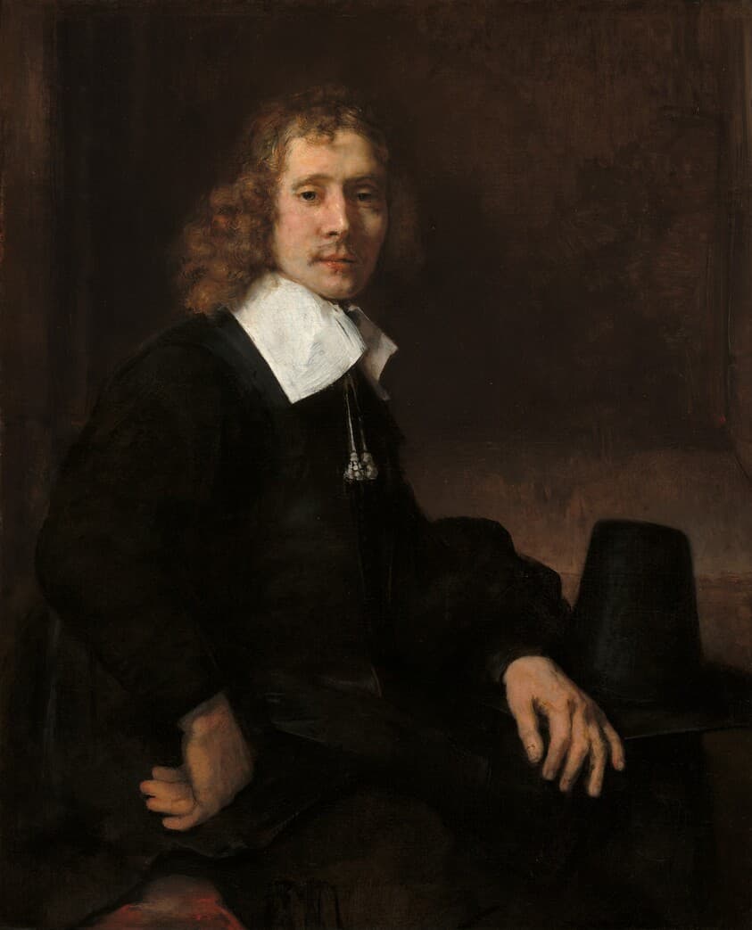 A Young Man Seated at a Table (possibly Govaert Flinck) — Rembrandt van Rijn