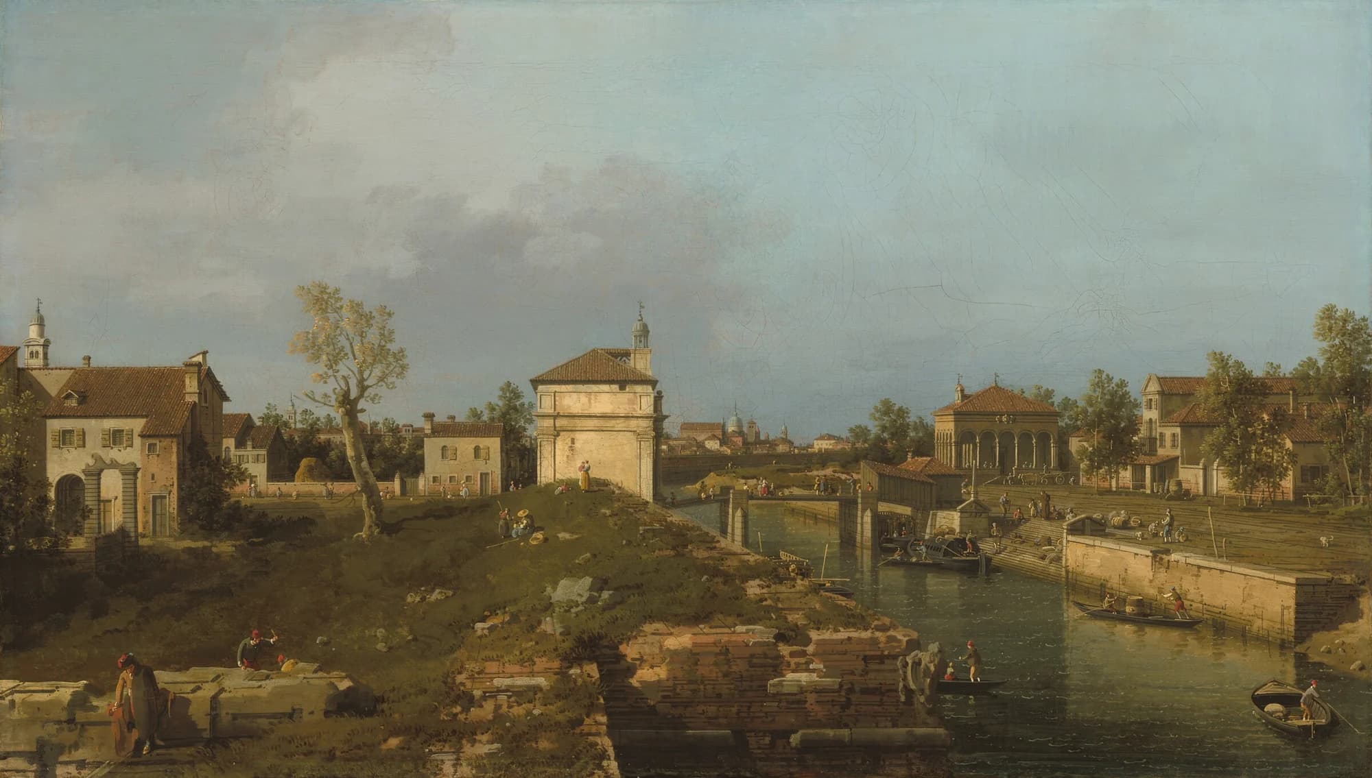 Canaletto, The Porta Portello, Padua, c. 1741/1742, oil on canvas: a canal town under a wide pale sky, with a stone gateway on a green bank, a colonnade and tiled roofs along the far side, and small boats working at a lock in the foreground.
